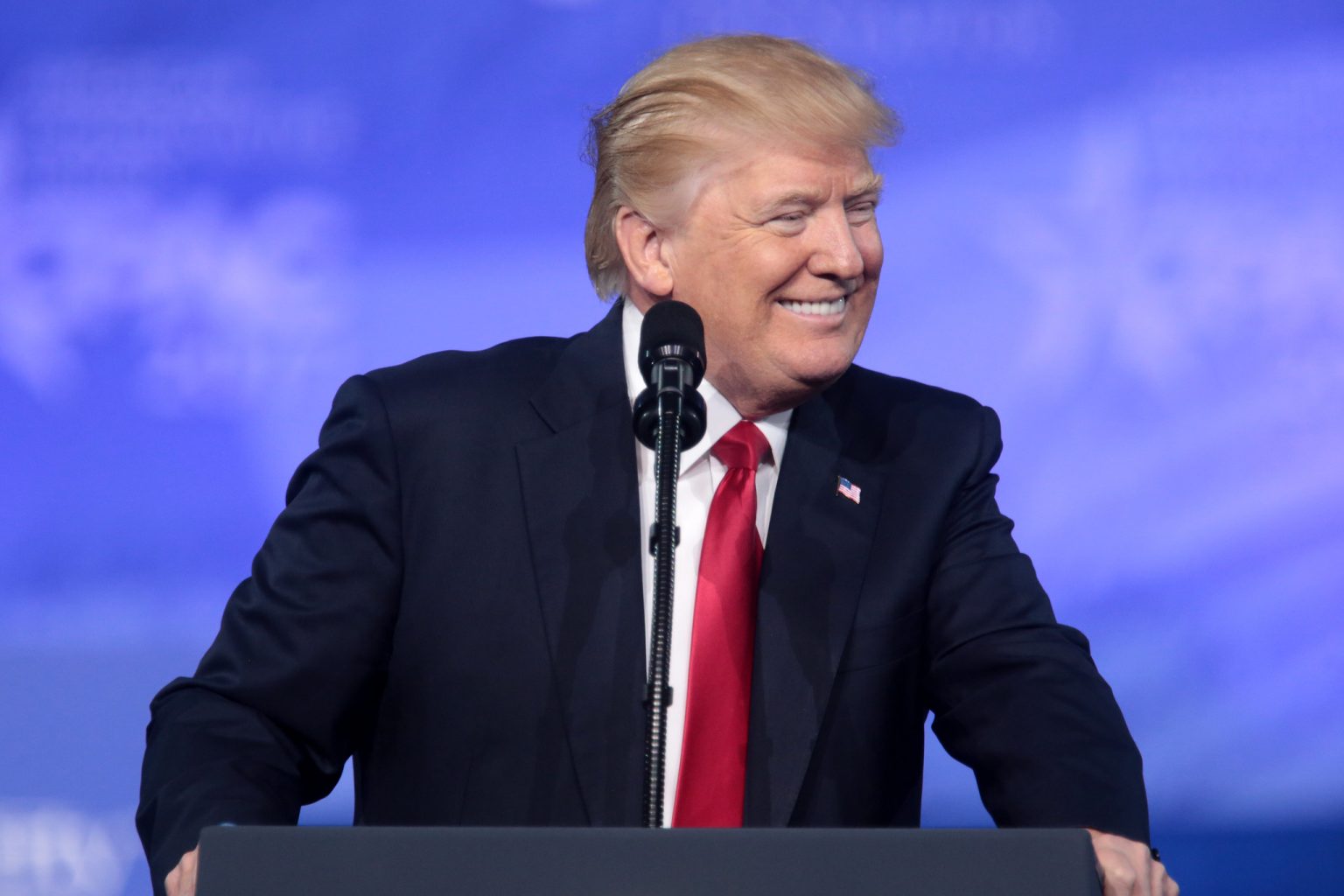 Donald Trump smiling at a conference