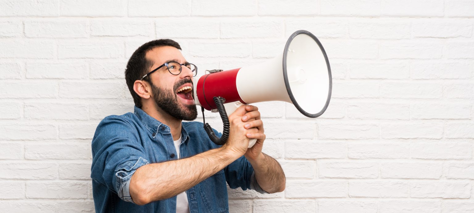 Man houting through megaphone