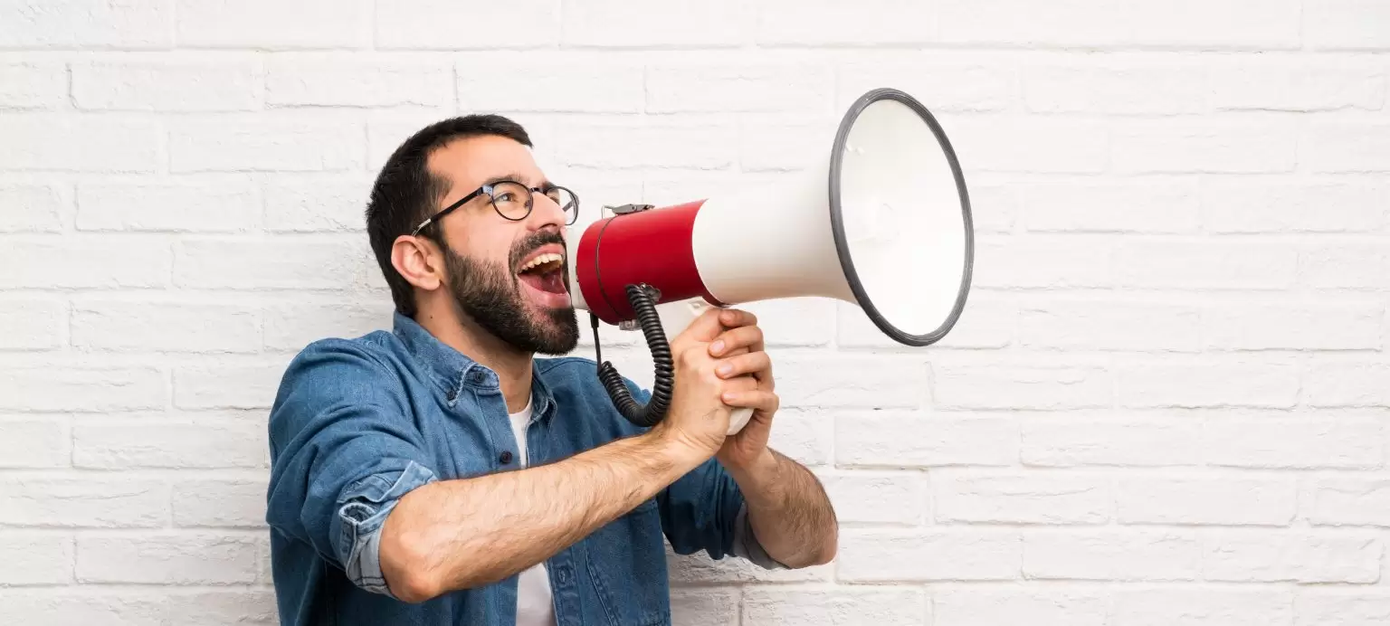 Man houting through megaphone