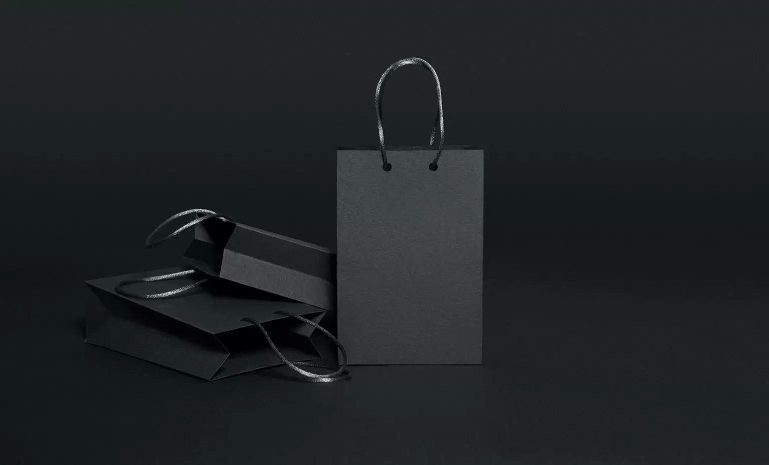 Black shopping bags on black background
