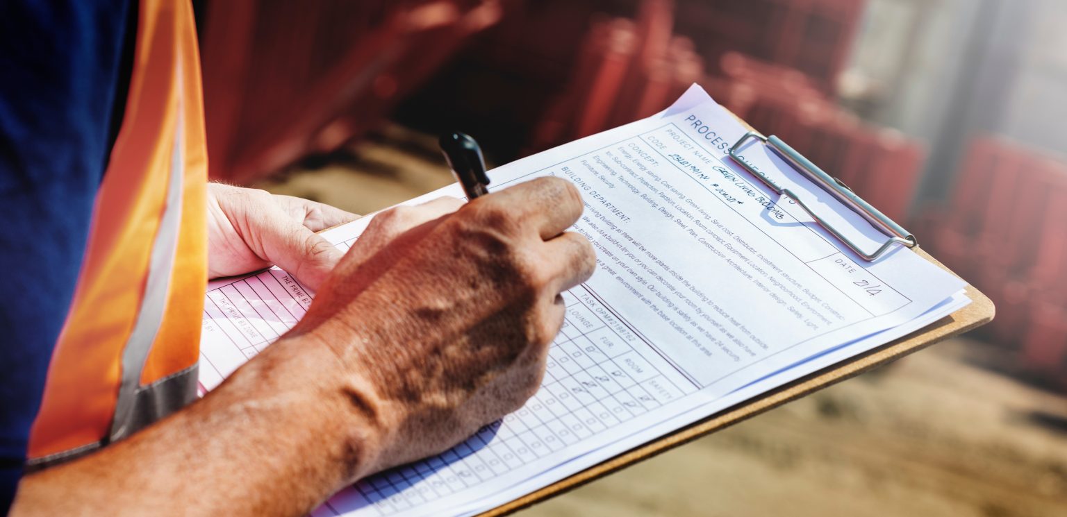 person filling out a form/survey on a clip board
