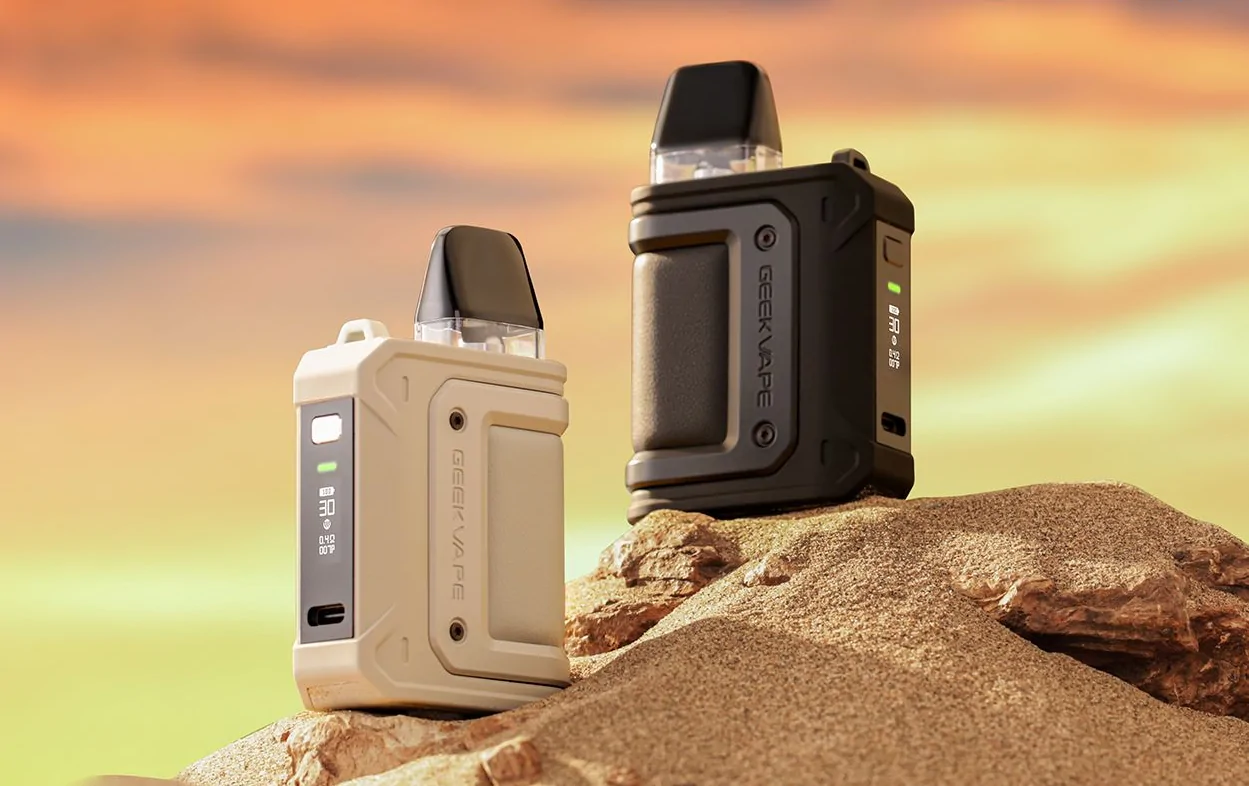geekvape aegis hero q refillable vape pod system in white and black on a sandy background